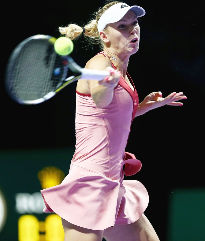 Caroline Wozniacki of Denmar plays a forehand against Serena Williams