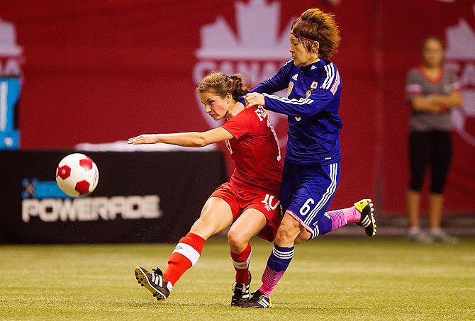 Jessie Fleming #10 of Canada pass the pass while getting challenged by Mizuho Sakaguchi #6 of Japan in Women's International Soccer Friendly