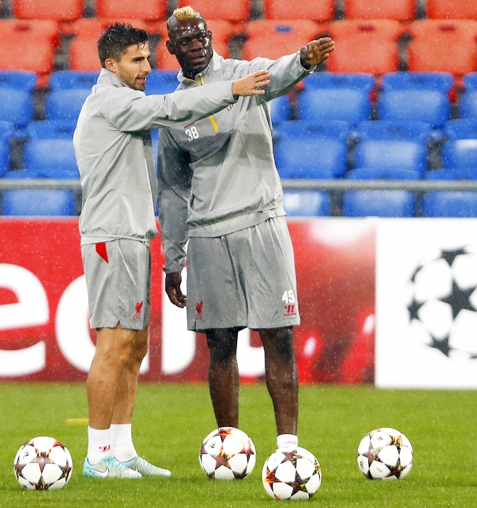 Liverpool's Mario Balotelli and teammate Fabio Borini