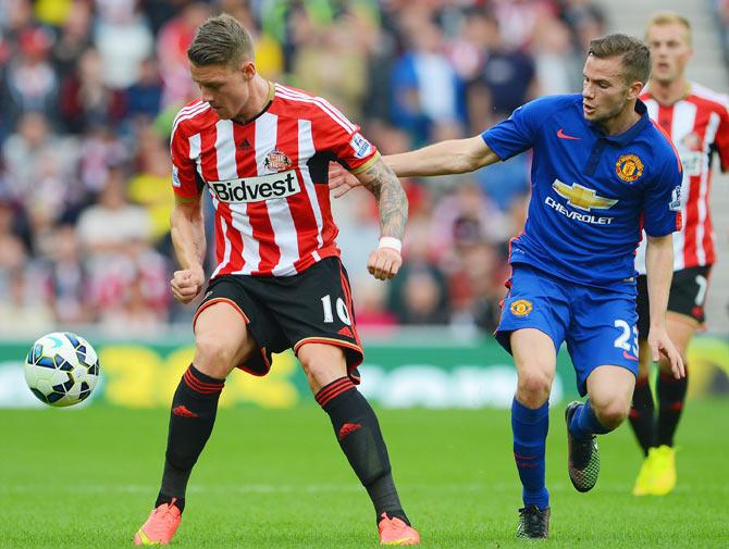 Connor Wickham of Sunderland is closed down by Tom Cleverley of Manchester United during their Barclays Premier League match