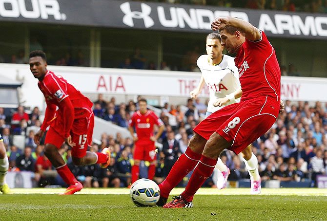 Liverpool's Steven Gerrard (right) scores from a penalty during their English Premier League match against Tottenham Hotspur at White Hart Lane on Sunday