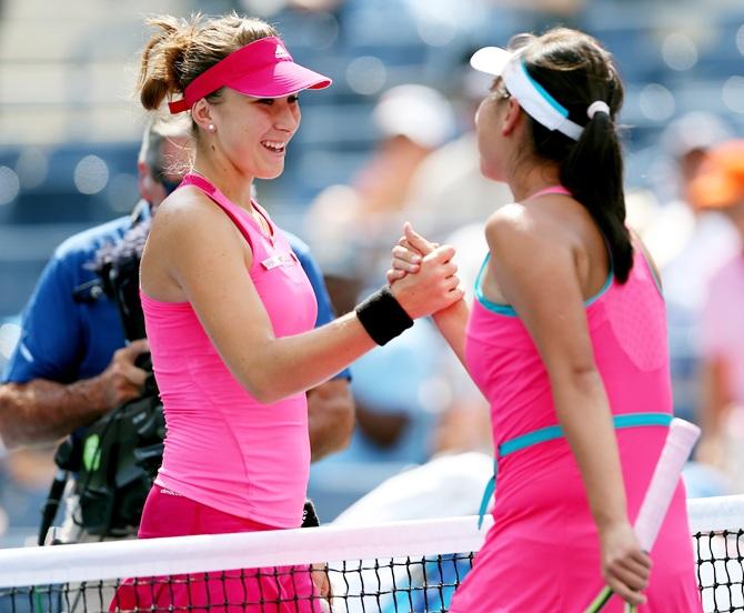 Shuai Peng of China shakes hands with Belinda Bencic