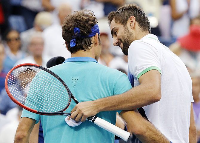 Marin Cilic of Croatia (right) and Roger Federer of Switzerland embrace after their semifinal on Saturday