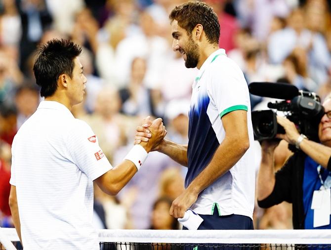 Marin Cilic, right, of Croatia greets Kei Nishikori of Japan