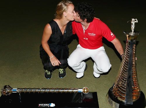 Rory McIlroy of Northern Ireland kisses Caroline Wozniacki