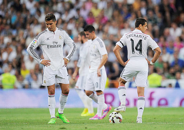 Cristiano Ronaldo of Real Madrid reacts beside Javier 'Chicharito' Hernandez after Atletico de Madrid scored their 2nd goal