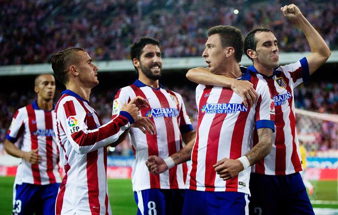 Atletico de Madrid's Mario Mandzukic (2nd from right) celebrates with teammates Diego Godin (right), Raul Garcia (2nd from left) and Antoine Griezmann (left) during their La Liga match