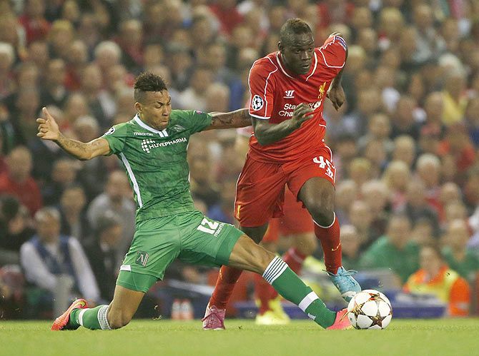 Liverpool's Mario Balotelli (right) challenges Ludogorets' Anicet Abel during their Champions League match at Anfield on Tuesday