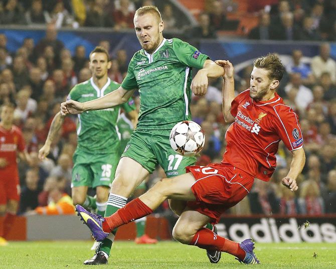 Liverpool's Adam Lallana (right) challenges Ludogorets' Cosmin Moti during their Champions League match