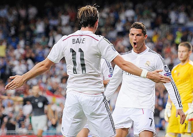 Cristiano Ronaldo of Real Madrid celebrates with Gareth Bale after scoring Real's 3rd goal against FC Basel 1893 during their UEFA Champions League Group B match on Tuesday