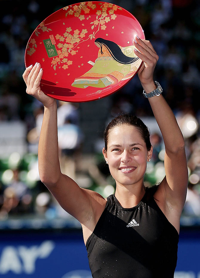 Ana Ivanovic celebrates with the trophy after winning the Tokyo Open on Sunday