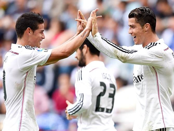 Cristiano Ronaldo of Real Madrid CF celebrates with his teammate James Rodriguez 
