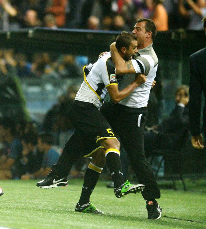 Danilo Larangeira (left) of Udinese Calcio celebrates with assistant coach Dejan Stankovic after scoring his opening goal agianst SSC Napoli on Sunday