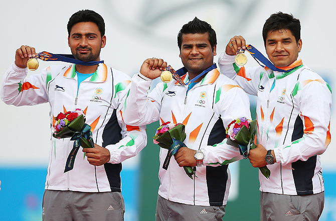 Gold medalists, Rajat Chauhan, Sandeep Kumar and Abhishek Verma of India on the podium following their Men's Compound Men's Team Gold Medal Match during the 2014 Asian Games at Gyeyang Asiad Archery Field on Saturday