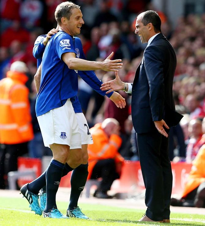 Phil Jagielka, left, celebrates with Roberto Martinez