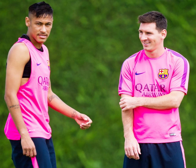 Neymar, left, and Lionel Messi look on during a FC Barcelona training session