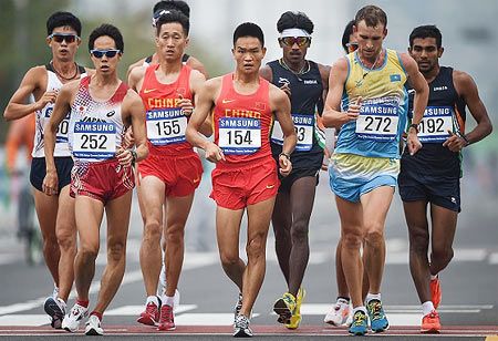 L-R: Choe Byeong-Kwang of South Korea, Yusuke Suzuki of Japan, Wang Zhen of China, Cai Zelin of China, Krishnan Ganapathi of India, Georgiy Shieko of Kazakhstan, and Kolothum Thodi Irfan of India compete in the men's 20km race walk event of the 2014 Incheon Asian Games on Sunday