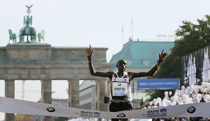 Dennis Kimetto of Kenya crosses the finish line in a new world record time to win the 41st Berlin marathon on Sunday