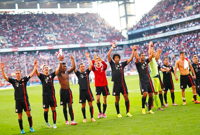 Bayern Munich's players celebrate after their German first division Bundesliga match against FC Cologne in Cologne