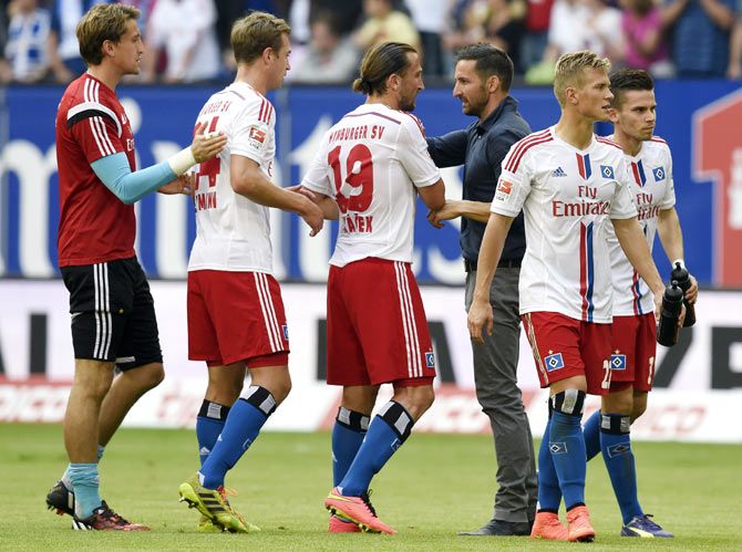 Hamburg SV's new head coach Josef Zinnbauer (3rd right) shakes hands with his players after their German Bundesliga first division soccer match