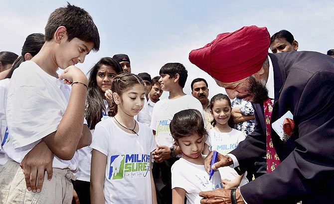 Legendary athlete Milkha Singh with children during the lauch of Milkha Surefit, a sports education programme for Indian school kids, in New Delhi, on Wednesday