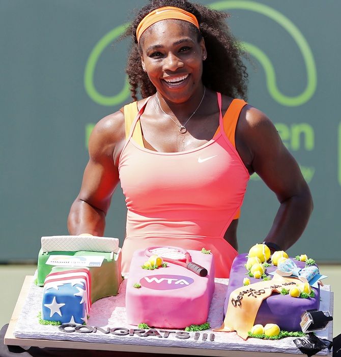 Serena Williams poses with a cake