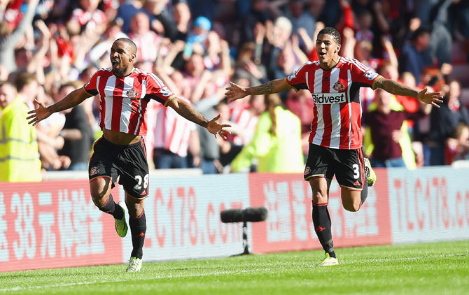 Jermain Defoe of Sunderland (left) celebrates with teammate Patrick van Aanholt after scoring the opening goal against Newcastle United during their English Premier League match at the Stadium of Light on Sunday