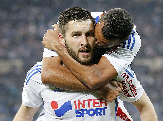 Olympique Marseille's Andre-Pierre Gignac (left) celebrates with teammates after scoring against Paris St Germain during their French Ligue 1 match at the Velodrome stadium in Marseille on Sunday.