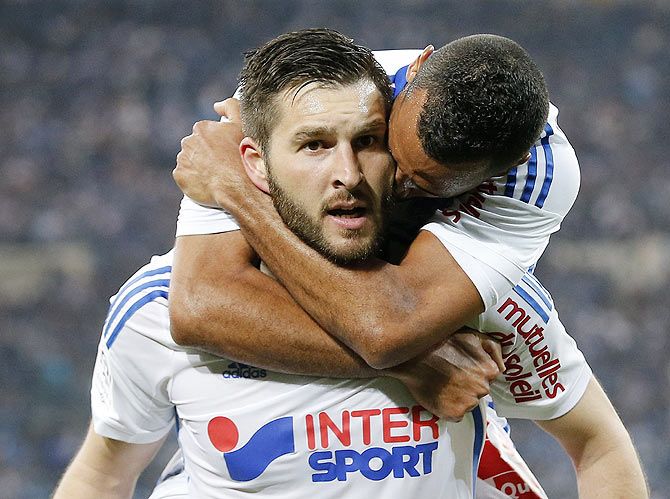 Olympique Marseille's Andre-Pierre Gignac (L) celebrates with teammates after scoring against Paris St Germain during their French Ligue 1 match at the Velodrome stadium in Marseille on Sunday