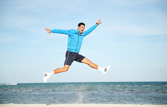 Novak Djokovic of Serbia leaps in the air on Crandon Park beach as he celebrates his Miami Open win on Sunday