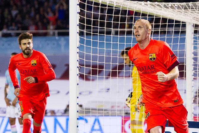 FC Barcelona's Jeremy Mathieu celebrates after scoring the opening goal against Celta Vigo during the La Liga match at Estadio Balaidos in Vigo on Sunday