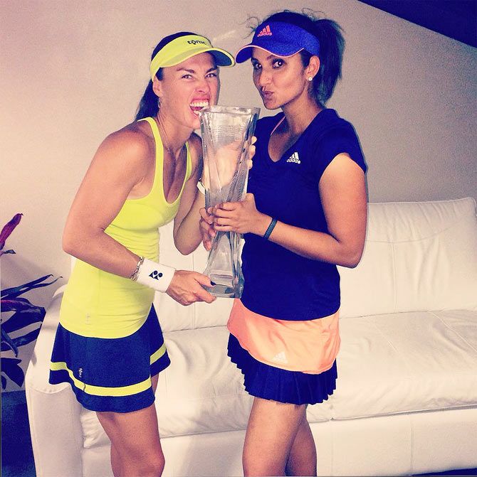 Martina Hingis and Sania Mirza clown around after winning the Miami Open doubles title on Sunday