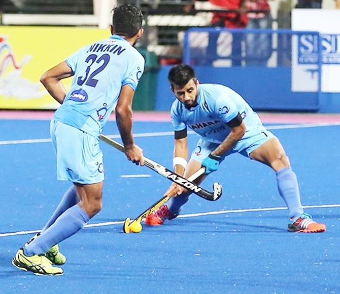 India's Manpreet Singh (right) in action
