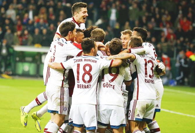 Bayern Munich players celebrate after scoring the decisive penalty to defeat Bayer Leverkusen in their German Cup (DFB-Pokal) quarter-final in Leverkusen on Wednesday