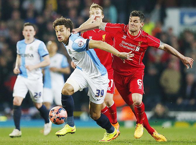 Liverpool's Dejan Lovren and Blackburn's Rudy Gestede vie for possession