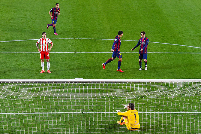 FC Barcelona's Luis Suarez celebrates with teammate Lionel Messi after scoring his team's second goal against UD Almeria at Camp Nou on Wednesday