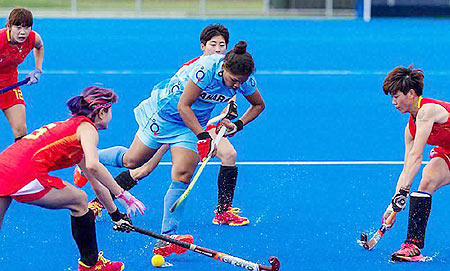 An Indian hockey player tries to get past the Chinese players in the opening game of the Hawke’s Bay Cup in New Delhi on Saturday