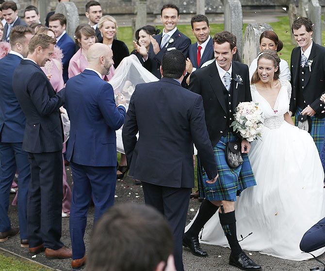 Tennis player Andy Murray and wife Kim Sears are greeted by guests as they leave the cathedral after their wedding at a cathedral in Dunblane, Scotland, on Saturday