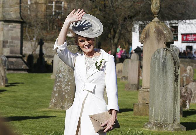 Judy Murray waves as she arrives at the cathderal for the wedding of her son tennis player Andy Murray to Kim Sears