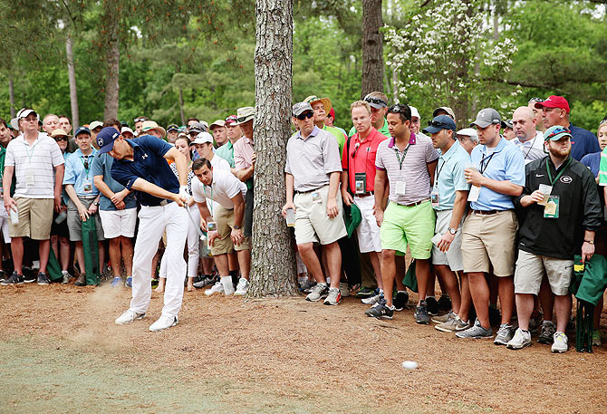 Jordan Spieth of the United States hits a shot out of the pine straw on the 11th hole during the final round