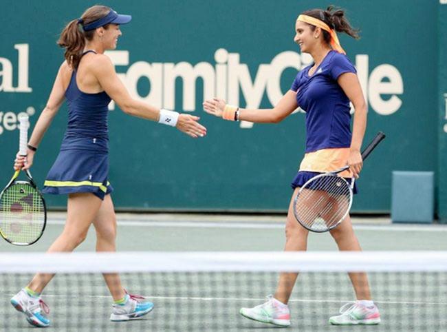 Sania Mirza (right) and her Swiss partner Martina Hingis celebrate a point