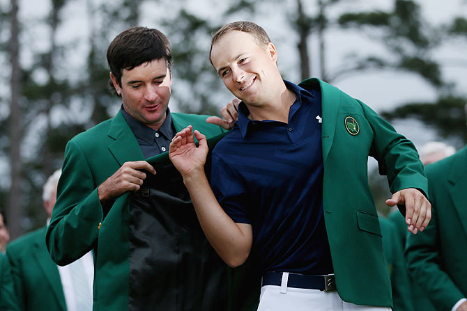 Bubba Watson presents Jordan Spieth of the United States with the green jacket after the latter won the 2015 Augusta Masters Tournament at Augusta National Golf Club in Augusta, Georgia, on Sunday