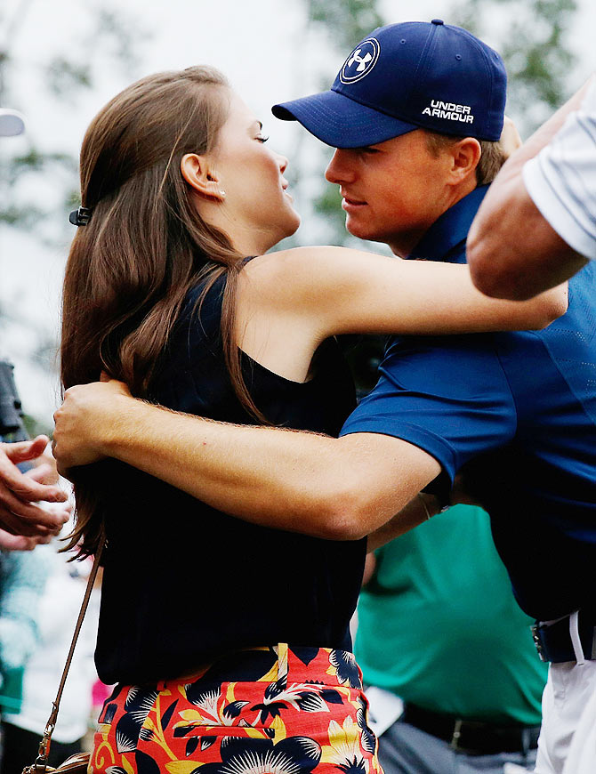 Jordan Spieth is greeted by his girlfriend Annie Verret behind the 18th green following is four-stroke victory at the 2015 Augusta Masters