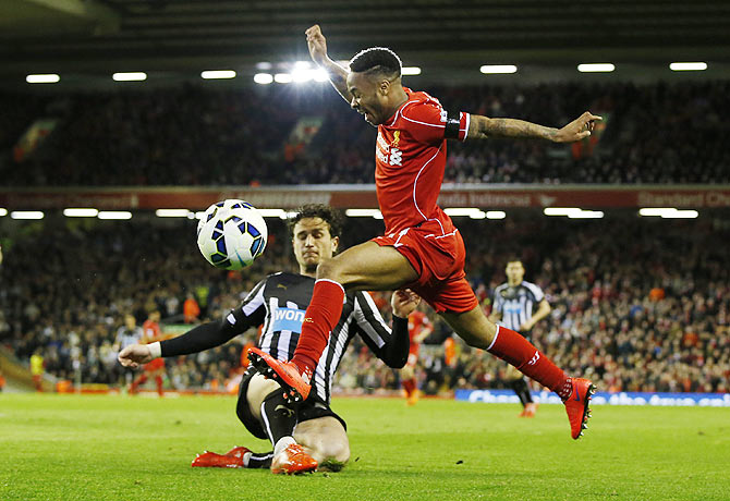 Liverpool's Raheem Sterling in challenged by Newcastle's Daryl Janmaat