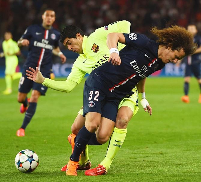 Neymar of Barcelona and David Luiz of PSG battle