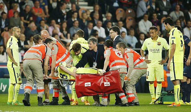 Barcelona's Andres Iniesta is stretchered off and substituted after sustaining an injury against PSG