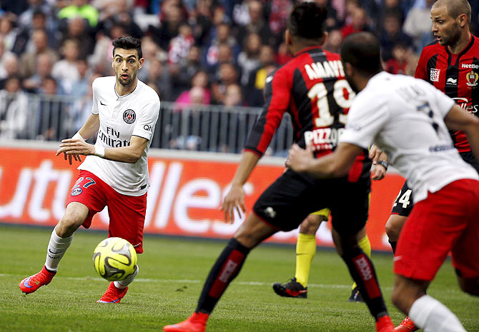 Paris St Germain's Javier Pastore (right) challenges Nice's Jordan Amavi to score a second goal during their Ligue 1 match at Allianz Riviera stadium in Nice on Saturday