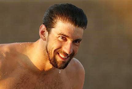 Image: Michael Phelps smiles to his family after winning in the 100 Meter Freestyle final during the 2015 Arena Pro Swim Series at the Skyline Aquatic Center in Mesa, Arizona on Saturday