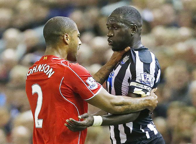 Newcastle's Moussa Sissoko clashes with Liverpool's Glen Johnson during their English Premier League match on April 12