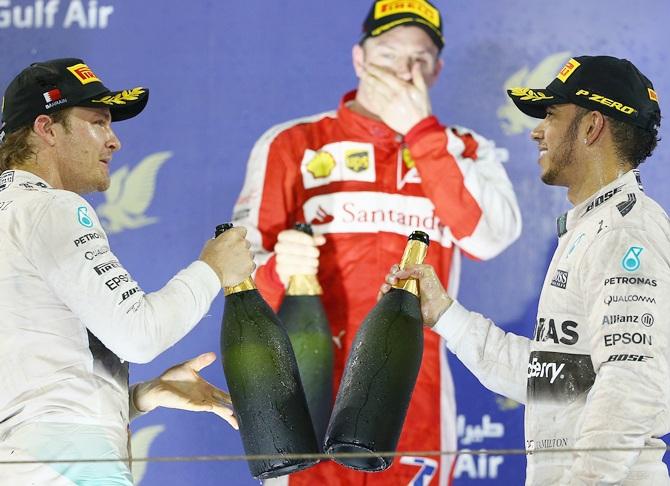  Kimi Raikkonen, centre, of Finland and Ferrari looks on